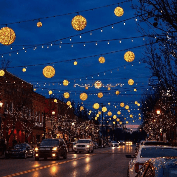 Festive lights over a city street at night